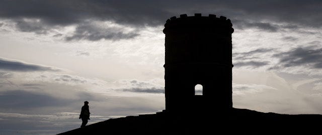 Silhouette of a large tower on a hill  