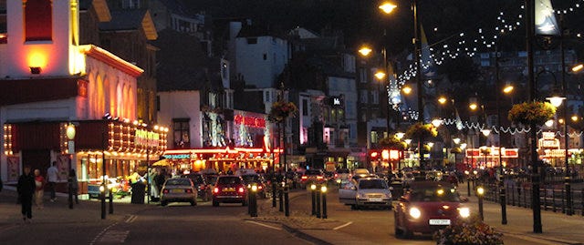 Scarborough seafront at night, illuminated by arcades and street lights