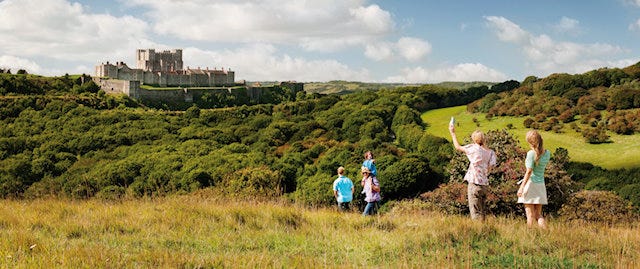 family walking with dover castle in the background 
