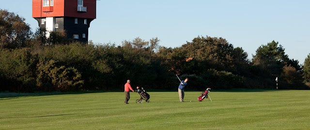 Two people playing golf