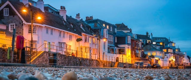 Street lights illuminating houses on the beach front