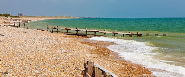 Beautiful winding beach with old wooden groynes