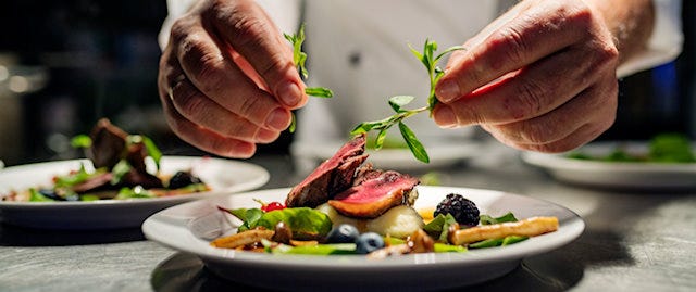 Chef putting final touches on plate