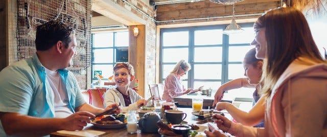 Family sat a table in restaurant