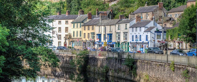 View over the river of some colourful houses in Matlock