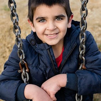 A young boy on a swing