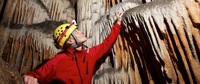 Hard-hatted adventurer exploring the caves