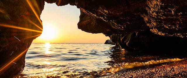 Sunset through a rock tunnel 