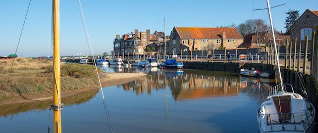 Boats moored at the harbourside in Blakeney