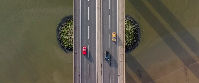 Cars traveling on bridge over water