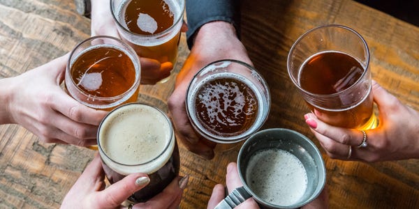 looking down over pints of beer on the table