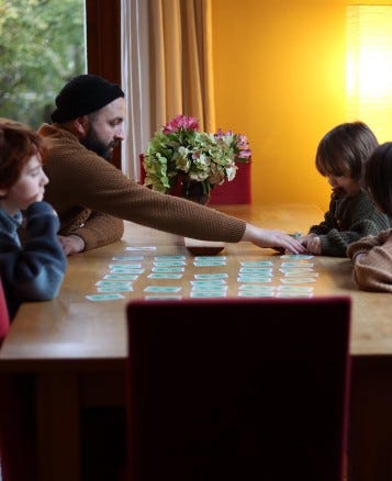 Family playing games at table
