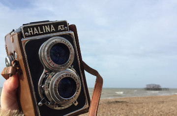 Old camera with the beach in the background