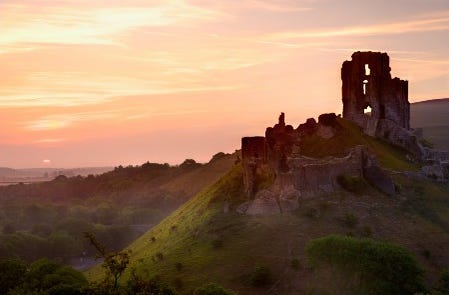 Corfe Castle ruins at sunset