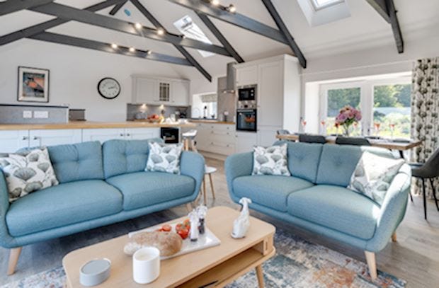 Two sky-blue sofas in a large open-plan property