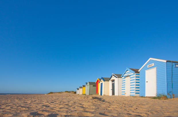 beach huts in a row on the beach