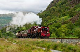 Five Child-Friendly Holidays That You Wish You’d Had Growing Up The Snowdon Mountain Railway engine puffing along the countryside in North Wales