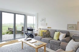 Open plan living area in shades of grey and cream