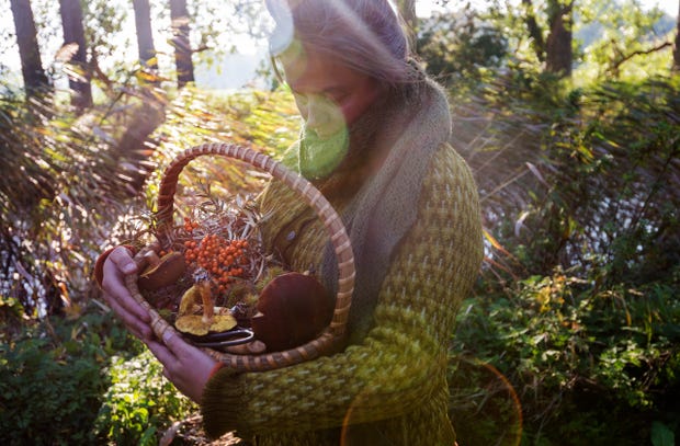 Lady foraging with a basket full of wild produce