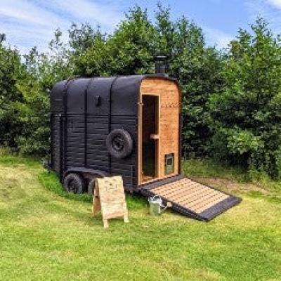 Converted horse box in feild with river access beside it