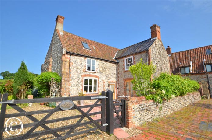 The traditional brick and flint farmhouse, built originally in the 1700s is full of character, has quirky features and a magnificent inglenook fireplace which is listed and described in Pevsner's Buildings of Norfolk.