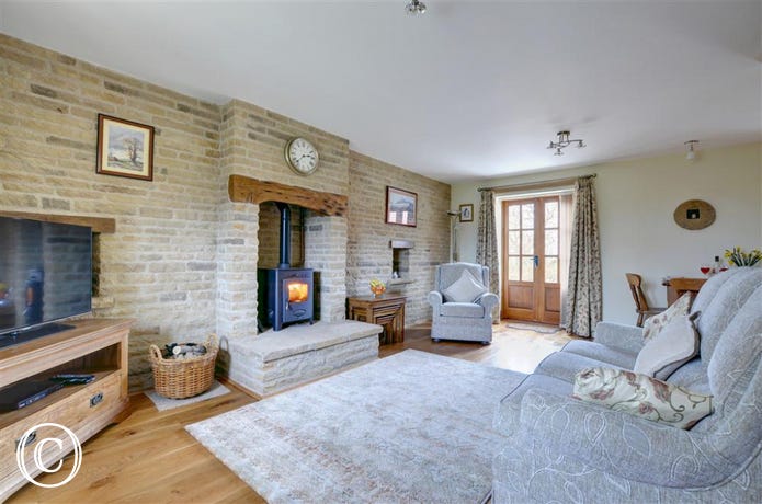 Comfortable, cosy lounge with wood-burning stove.