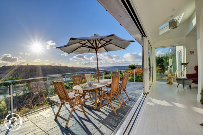 Sun terrace with seating and panoramic views across Lyme Bay