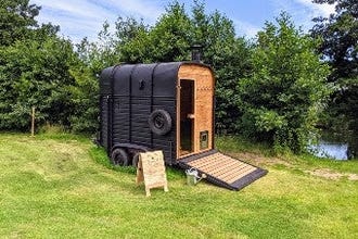 Converted horse box in feild with river access beside it